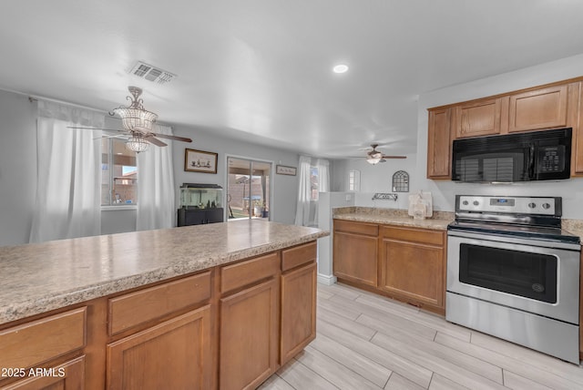 23693 W Grove St, Buckeye, AZ 85326 - kitchen featuring black microwave, stainless steel range with electric stovetop, ceiling fan, light countertops, and wood tiled floors