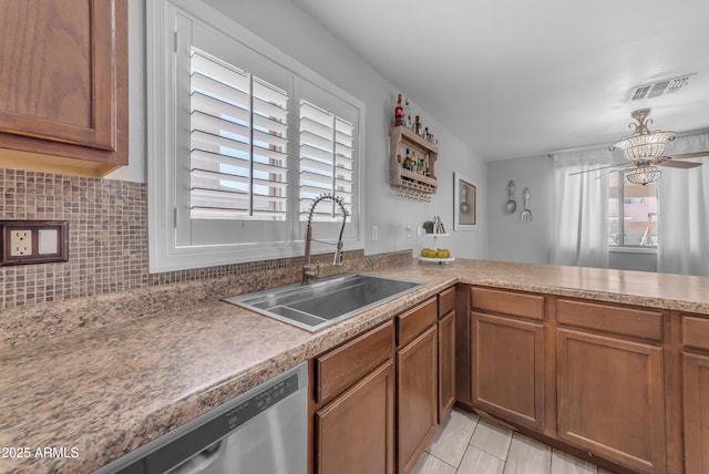 23693 W Grove St, Buckeye, AZ 85326 - kitchen with a sink, dishwasher, brown cabinetry, tasteful backsplash, and light tile patterned floors