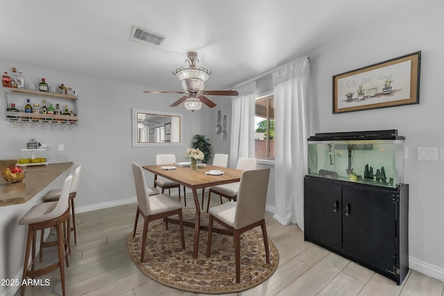23693 W Grove St, Buckeye, AZ 85326 - dining space featuring ceiling fan, light wood-style flooring, and baseboards
