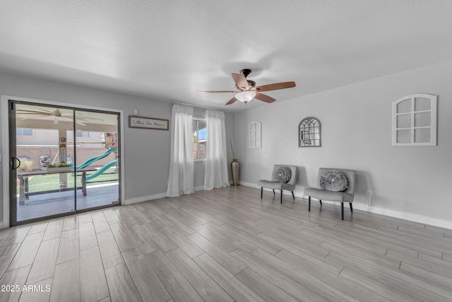 23693 W Grove St, Buckeye, AZ 85326 - sitting room with a ceiling fan, baseboards, and light wood-type flooring