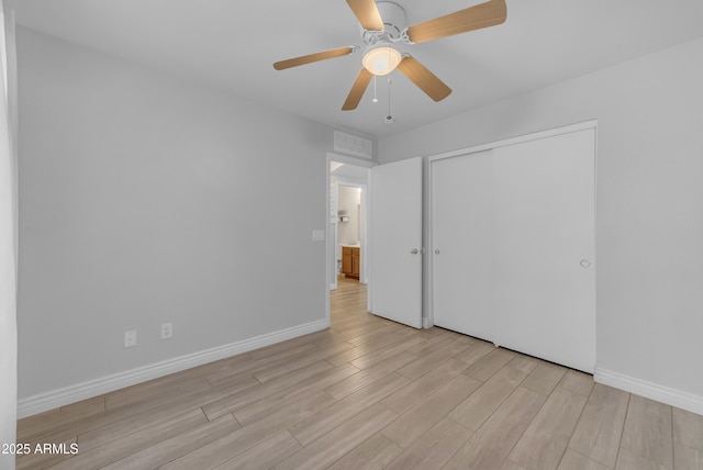23693 W Grove St, Buckeye, AZ 85326 - unfurnished bedroom with light wood-style floors, baseboards, a closet, and a ceiling fan