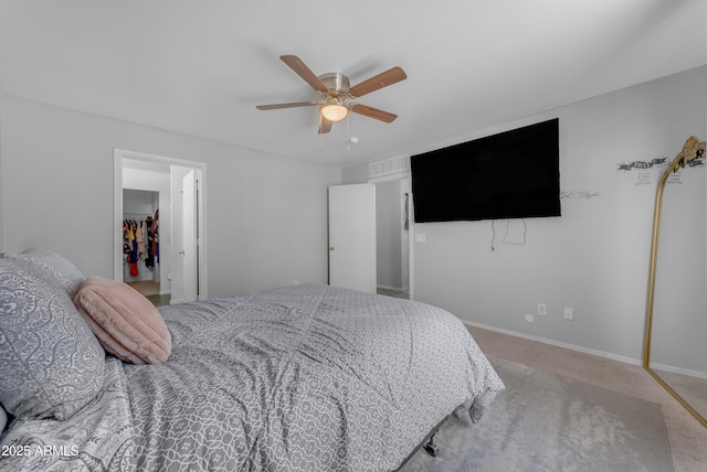 23693 W Grove St, Buckeye, AZ 85326 - bedroom featuring a spacious closet, light carpet, a ceiling fan, and baseboards