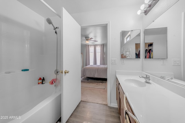 23693 W Grove St, Buckeye, AZ 85326 - bathroom with wood finished floors, vanity, ceiling fan, bathtub / shower combination, and ensuite bathroom