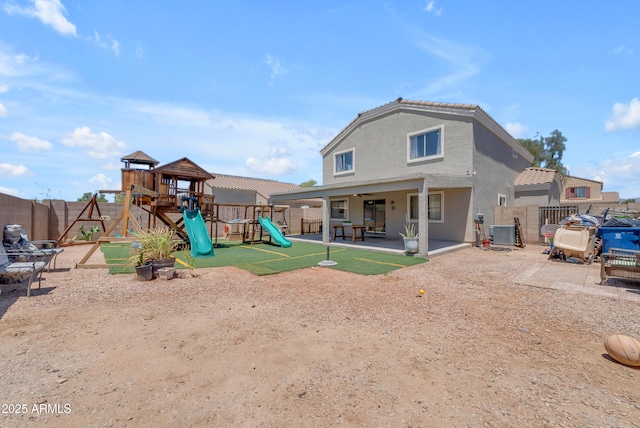 23693 W Grove St, Buckeye, AZ 85326 - rear view of property featuring a playground, a fenced backyard, central AC unit, and a patio