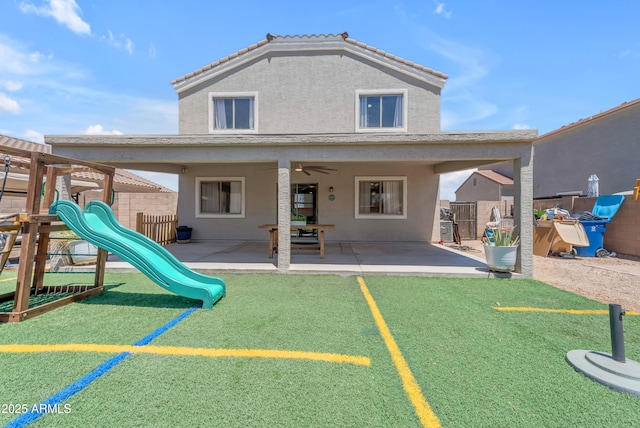 23693 W Grove St, Buckeye, AZ 85326 - back of property featuring a playground, a patio, fence, and stucco siding