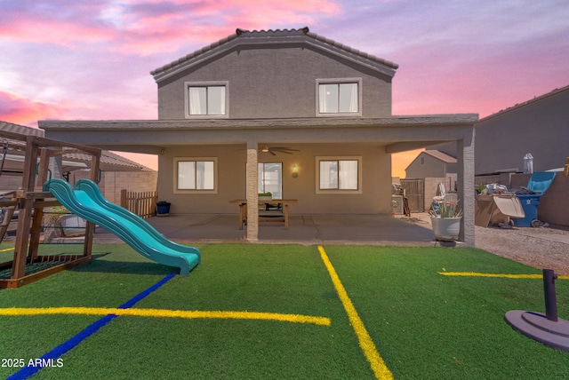 23693 W Grove St, Buckeye, AZ 85326 - rear view of property with stucco siding, a playground, and a patio