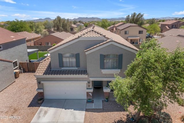 23693 W Grove St, Buckeye, AZ 85326 - view of front of property with a tile roof, concrete driveway, a mountain view, and stucco siding