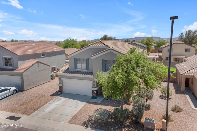 23693 W Grove St, Buckeye, AZ 85326 - view of front of house with driveway, an attached garage, a residential view, and a tiled roof