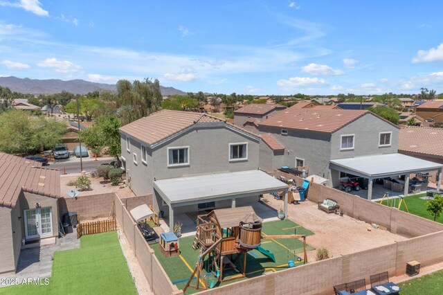23693 W Grove St, Buckeye, AZ 85326 - back of house with a residential view, french doors, a playground, a mountain view, and stucco siding