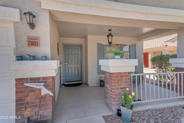 23693 W Grove St, Buckeye, AZ 85326 - doorway to property featuring a porch and stucco siding