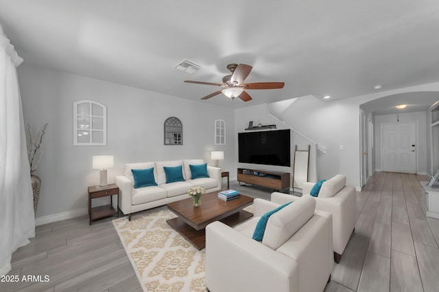 23693 W Grove St, Buckeye, AZ 85326 - living area with a ceiling fan, light wood-style flooring, arched walkways, baseboards, and recessed lighting