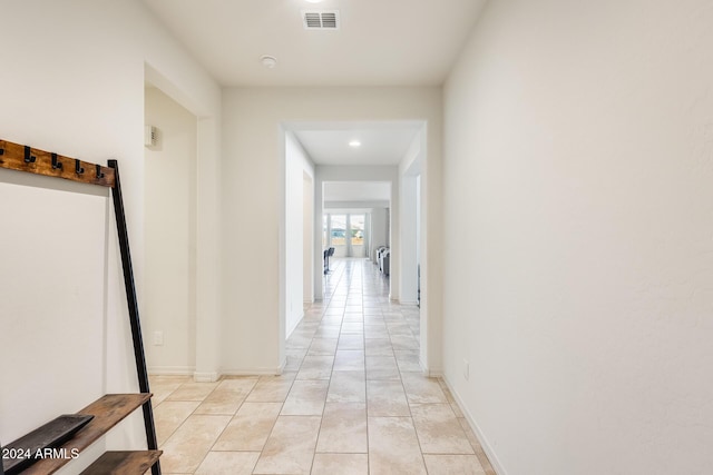 hallway featuring light tile patterned floors