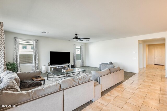 tiled living room with ceiling fan