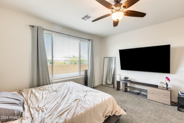 bedroom with ceiling fan and light carpet