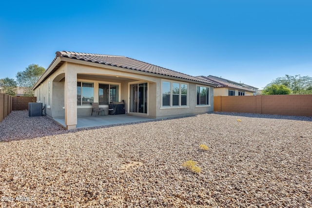 rear view of property with a patio and central AC unit