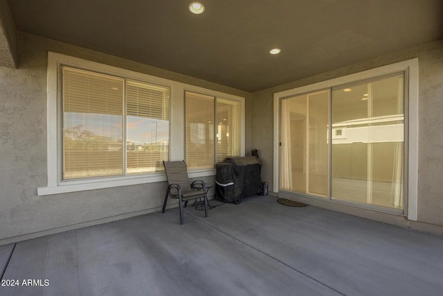 patio terrace at dusk featuring a grill