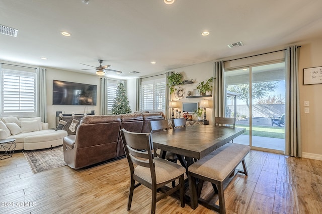 dining room with light hardwood / wood-style flooring, a wealth of natural light, and ceiling fan