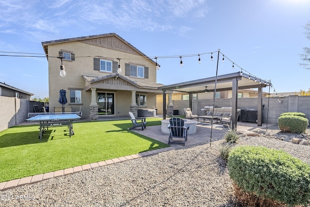 rear view of house featuring outdoor lounge area, a patio area, and a yard