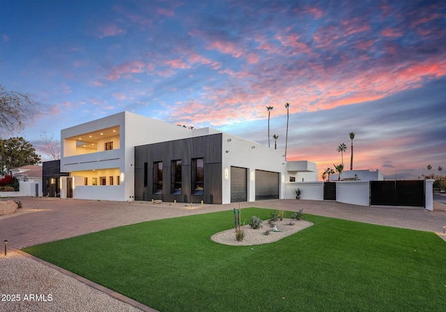 contemporary home with a lawn and a garage