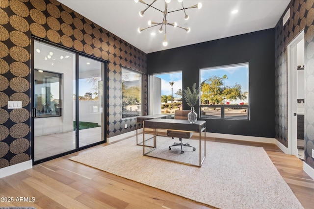 office space featuring light hardwood / wood-style floors, plenty of natural light, and a notable chandelier