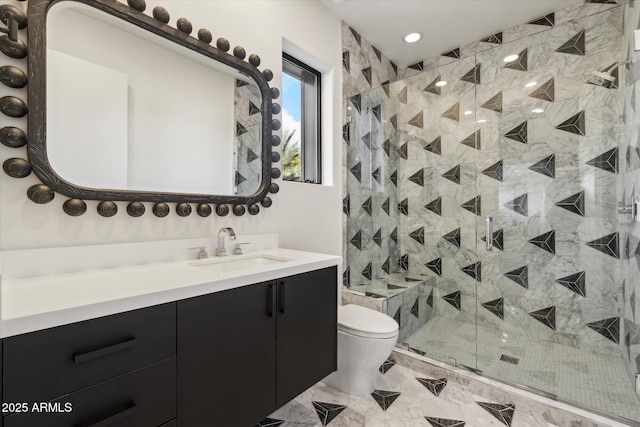 bathroom with vanity, a shower with shower door, and toilet