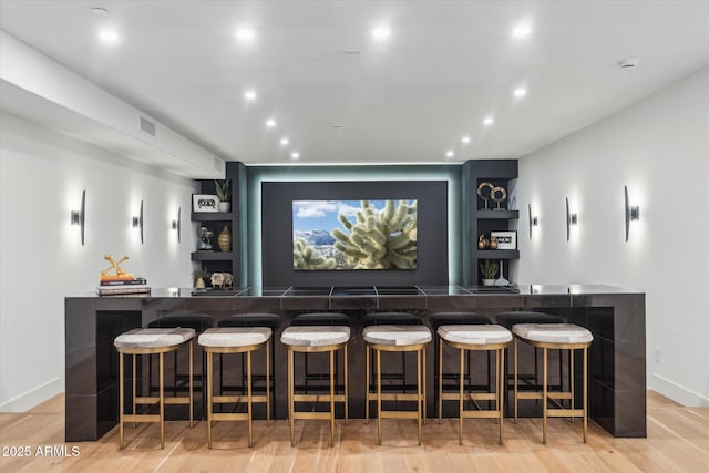 bar with light hardwood / wood-style floors