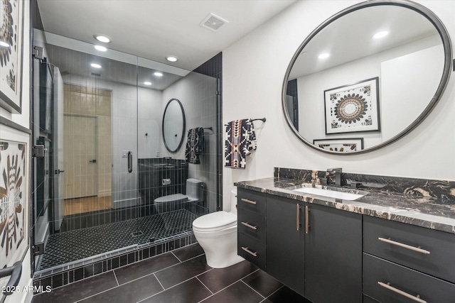 bathroom featuring toilet, tile patterned floors, walk in shower, and vanity