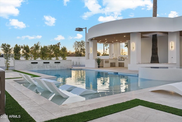 view of pool with area for grilling and a patio area