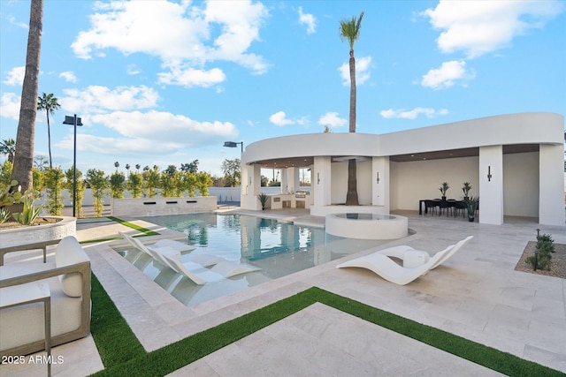 view of pool with a patio area and an in ground hot tub