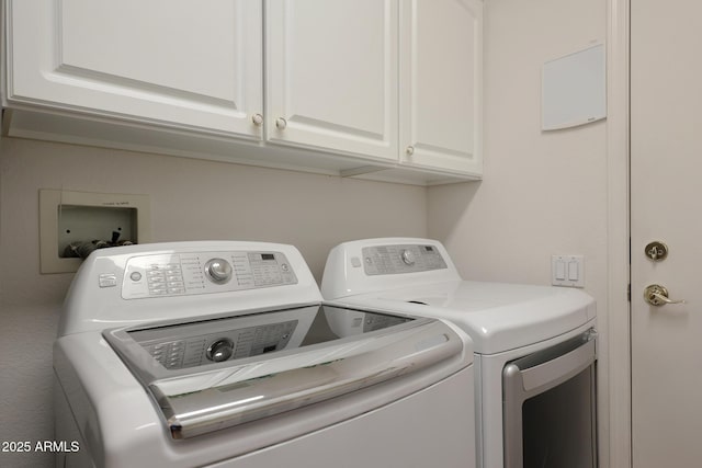 washroom featuring cabinet space and independent washer and dryer