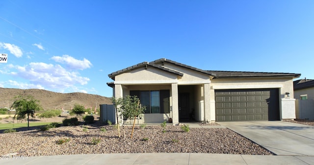 4923 W Weeping Willow Way, Laveen, AZ 85339 - ranch-style house featuring a garage, concrete driveway, a mountain view, and stucco siding