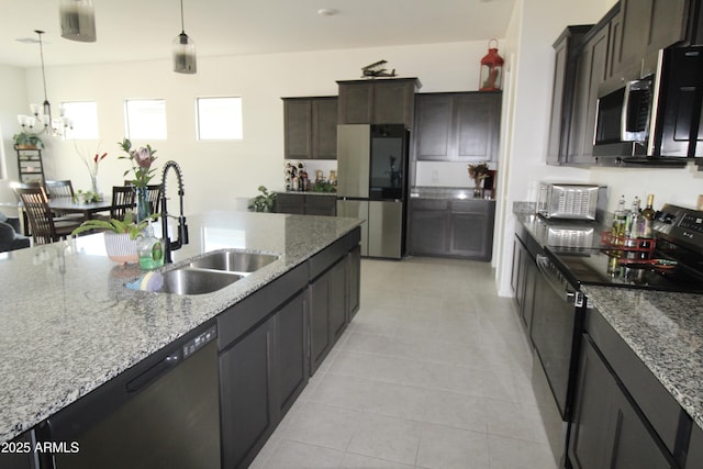 4923 W Weeping Willow Way, Laveen, AZ 85339 - kitchen featuring appliances with stainless steel finishes, a chandelier, and light stone countertops