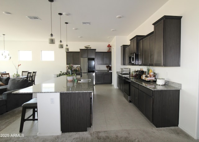 4923 W Weeping Willow Way, Laveen, AZ 85339 - kitchen with stainless steel appliances, open floor plan, a kitchen breakfast bar, light stone counters, and hanging light fixtures