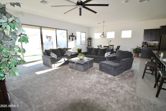 4923 W Weeping Willow Way, Laveen, AZ 85339 - living room with a ceiling fan, light carpet, and a chandelier
