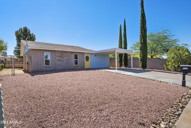 ranch-style house featuring a carport