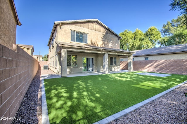 rear view of house with a lawn, central air condition unit, and a patio