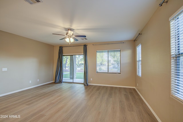 spare room with light hardwood / wood-style flooring and ceiling fan