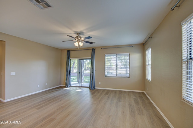 spare room with light wood-type flooring and ceiling fan