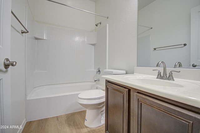 full bathroom featuring wood-type flooring, vanity, shower / bath combination, and toilet