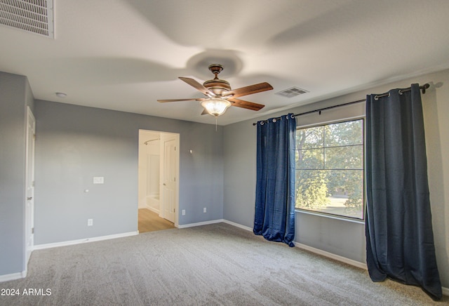 empty room with ceiling fan and light colored carpet