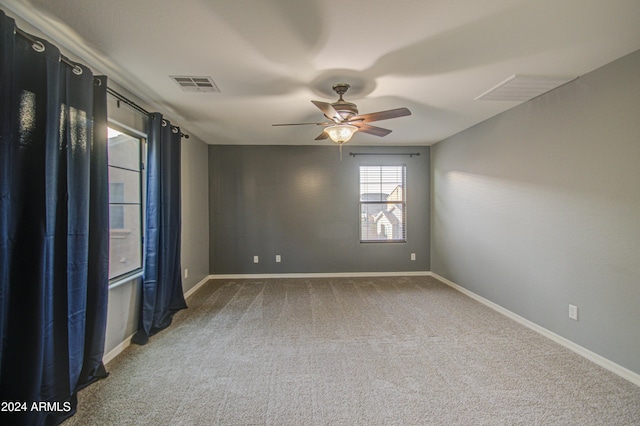 carpeted empty room featuring ceiling fan