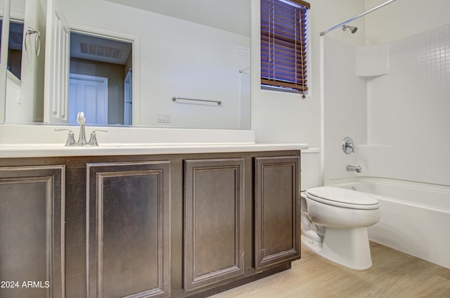 full bathroom with vanity, toilet, shower / bathing tub combination, and hardwood / wood-style flooring