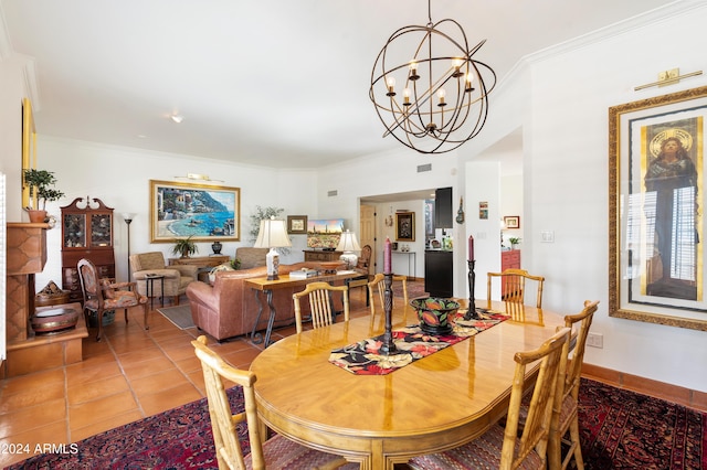 dining area featuring an inviting chandelier, crown molding, and tile patterned floors