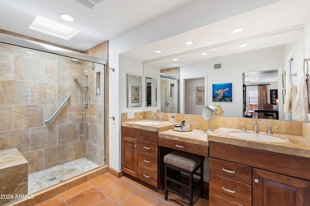 bathroom featuring vanity, an enclosed shower, and tile patterned floors