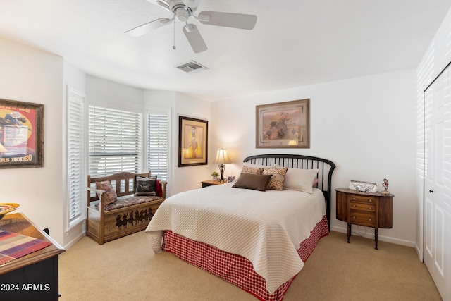 bedroom featuring light carpet, a closet, and ceiling fan