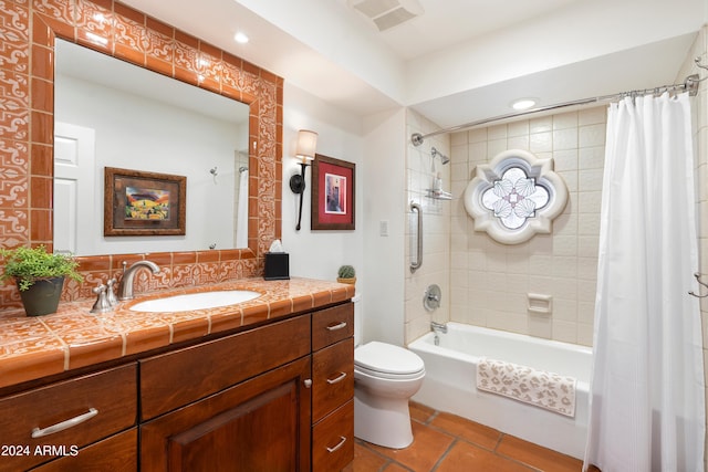 full bathroom with vanity, shower / bath combo with shower curtain, toilet, and tile patterned floors