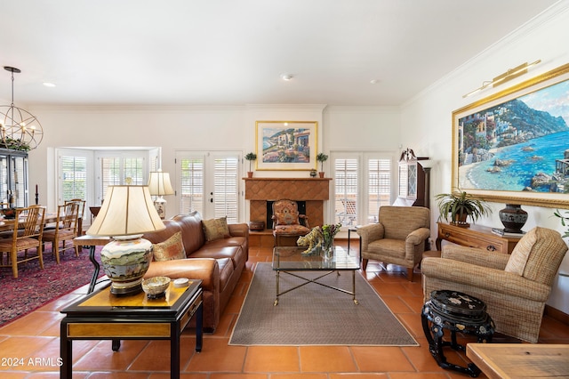 living room with crown molding, a tiled fireplace, a notable chandelier, and tile patterned floors