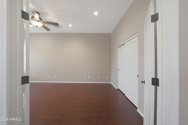 spare room featuring dark wood-type flooring and ceiling fan