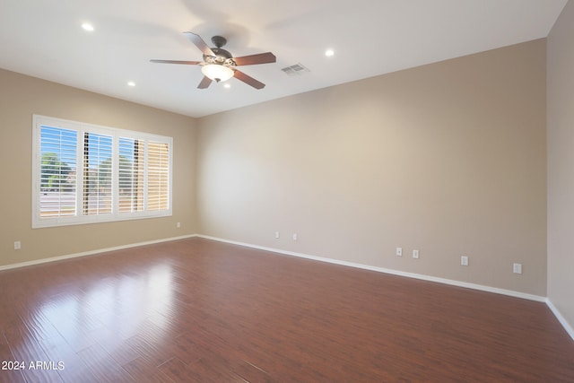 spare room featuring ceiling fan and dark hardwood / wood-style floors