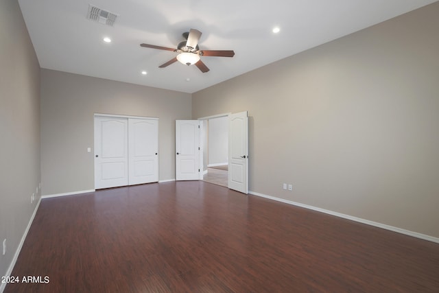 unfurnished bedroom featuring a closet, ceiling fan, and dark hardwood / wood-style floors